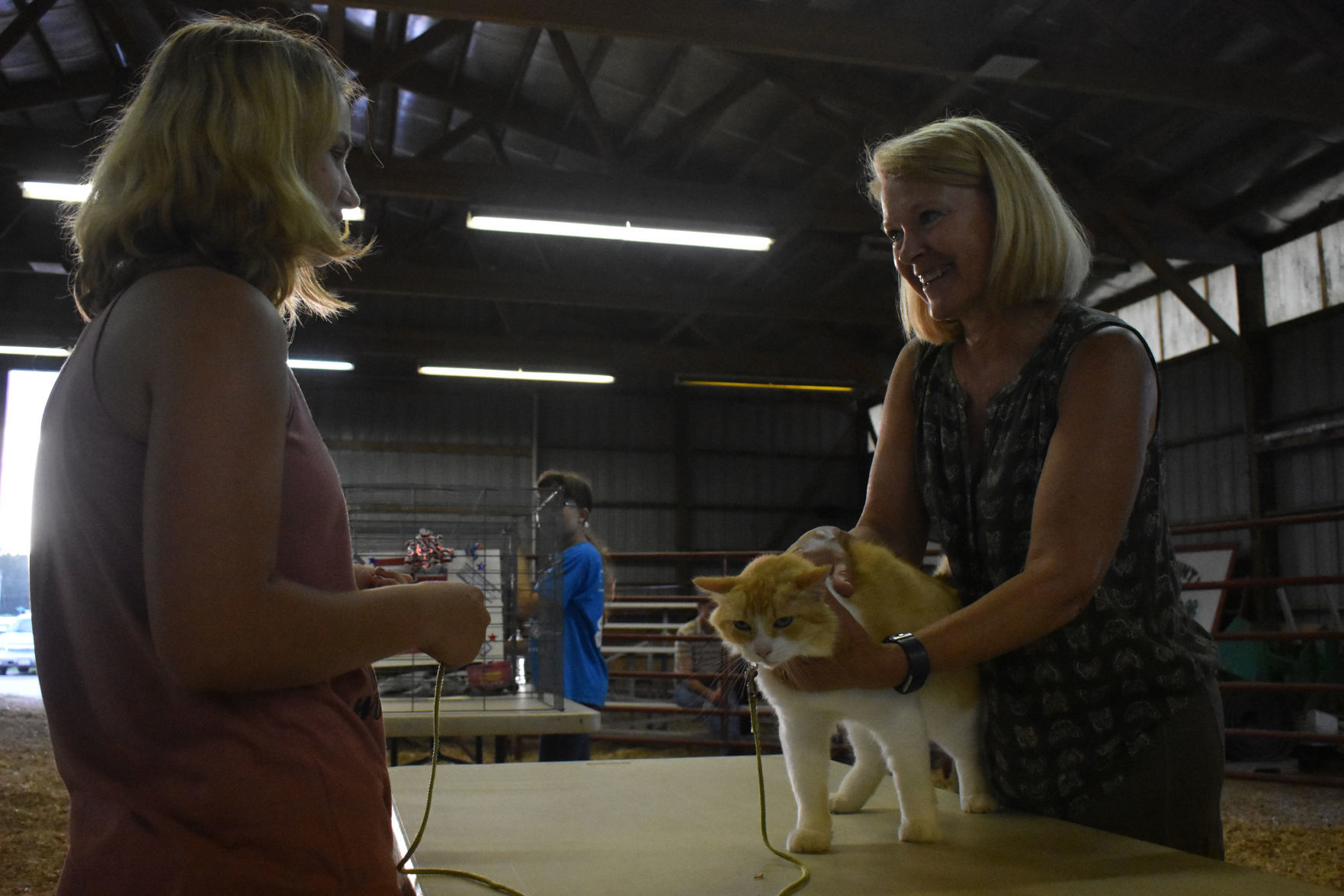 Kylee Beckius tells fair contest judge about her cat